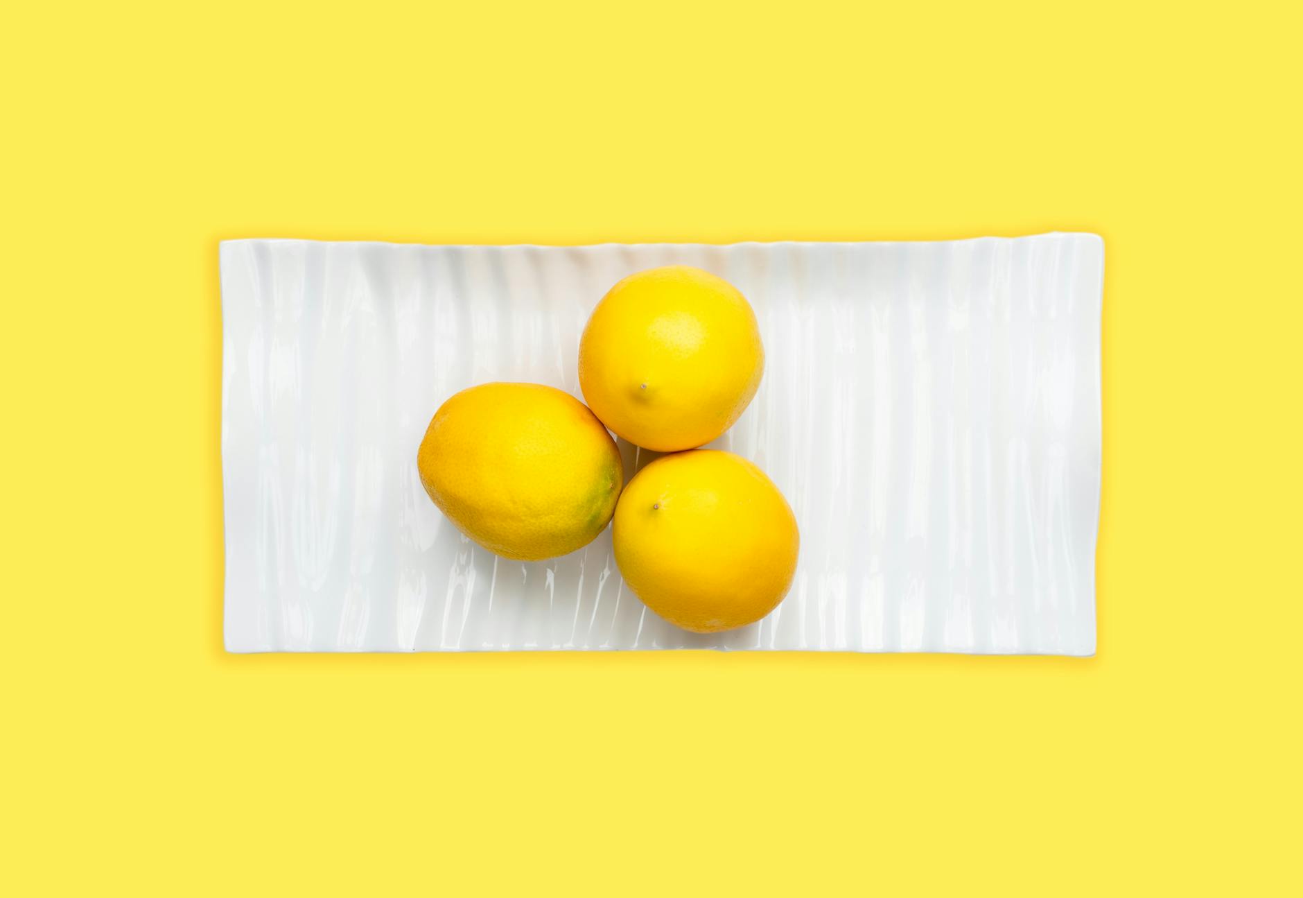 Fresh lemons arranged on a white plate, symbolizing renewal and fresh starts during life transitions
