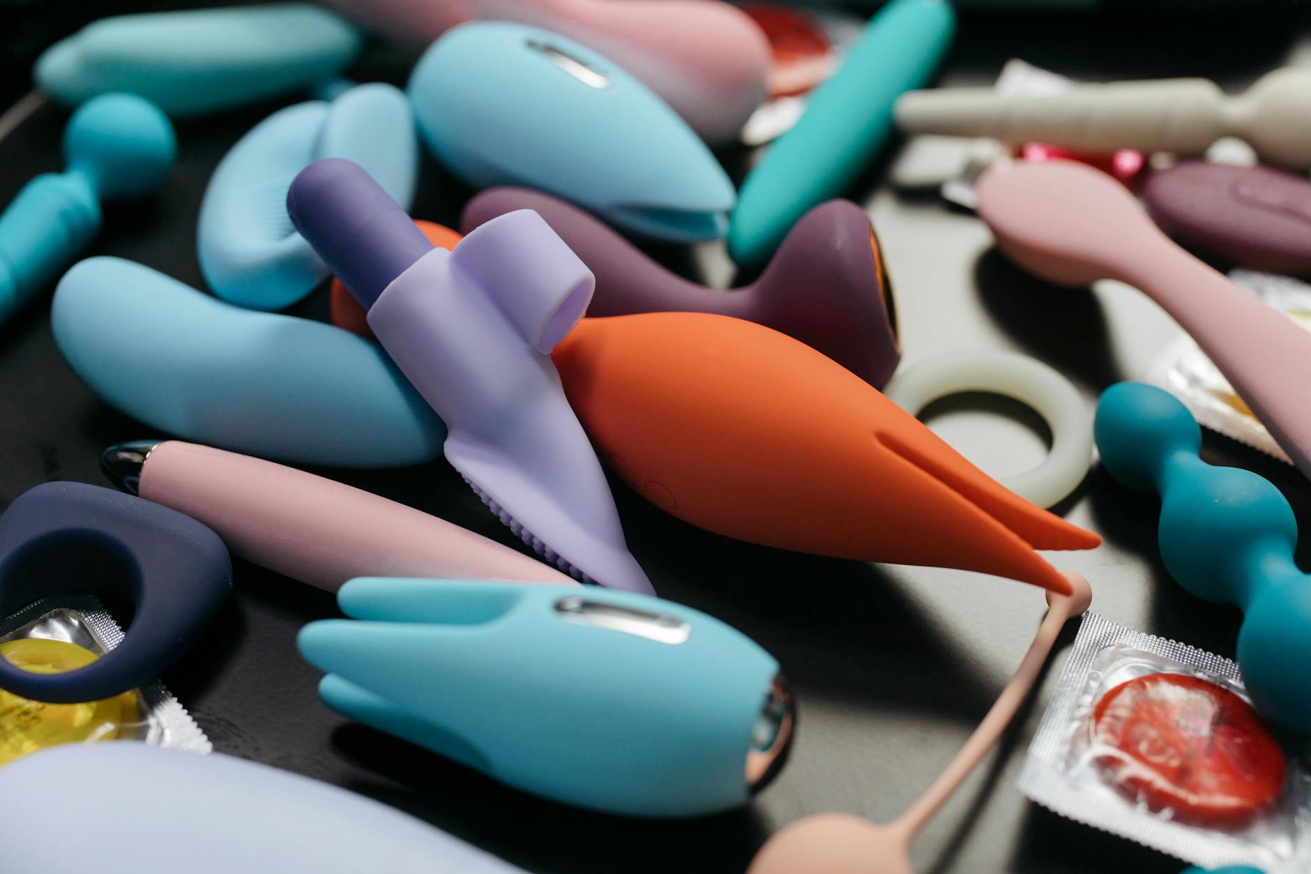 Hands holding a blue personal massager against a knitted sweater