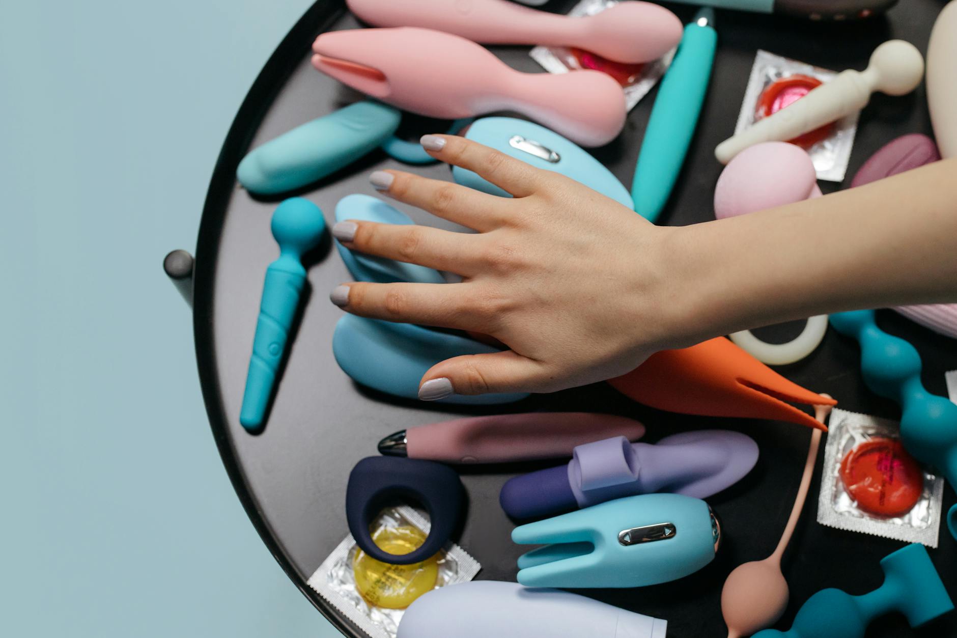 Three colorful vibrators arranged on white fabric, highlighting their smooth texture and design