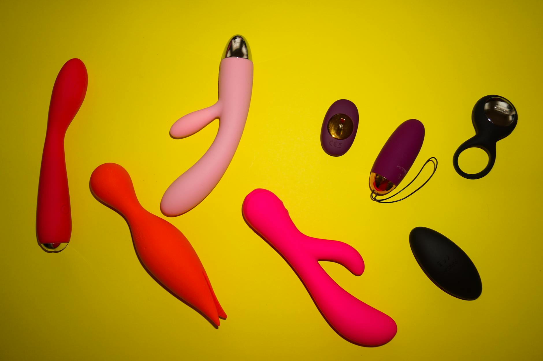 Hands holding pastel-colored silicone toys, showing intimate connection and trust between partners